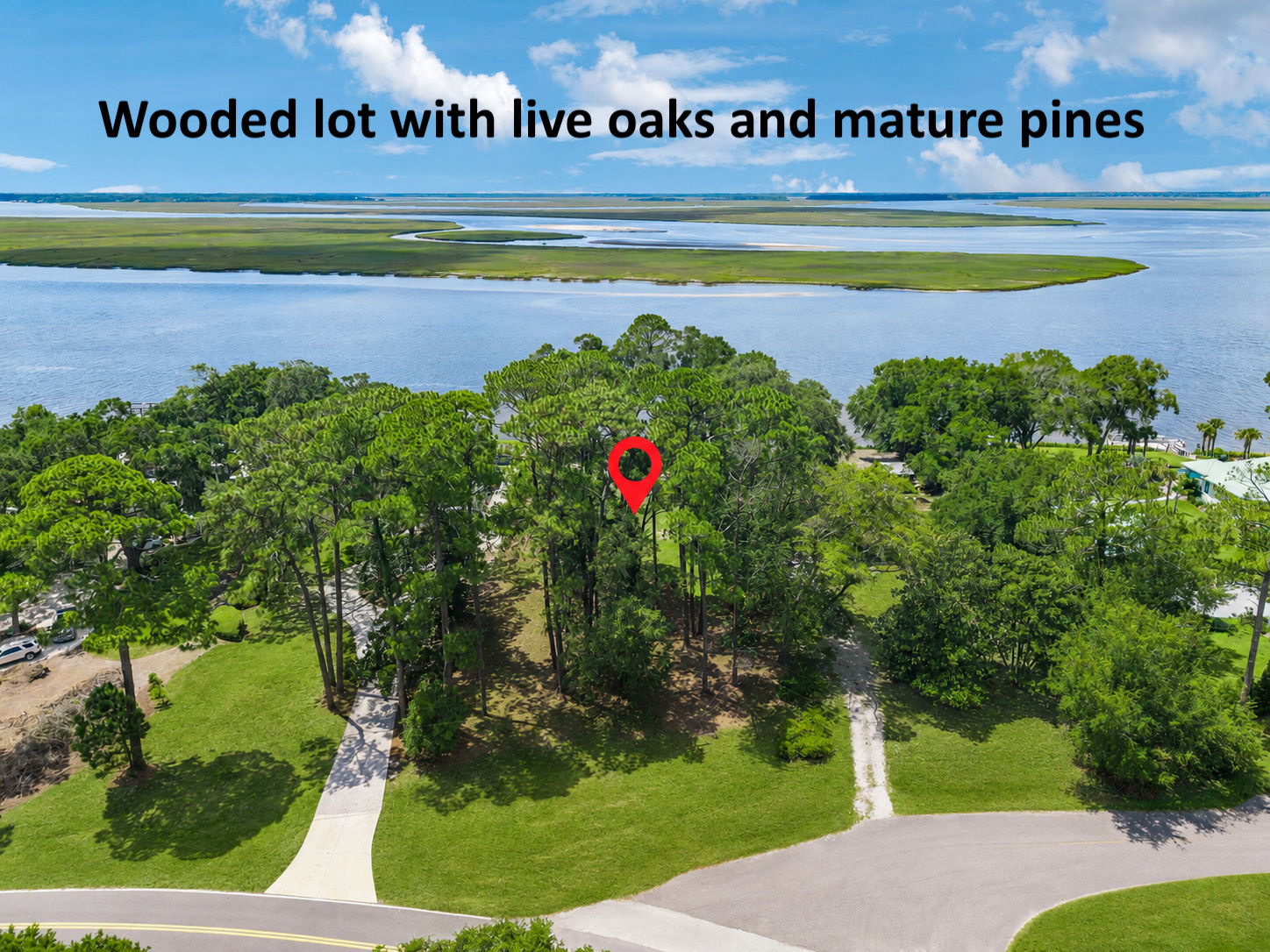 The wooded homesite is framed by mature live oaks and pines, offering natural beauty, shade and privacy.