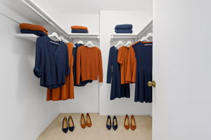 Virtually staged primary walk-in closet.