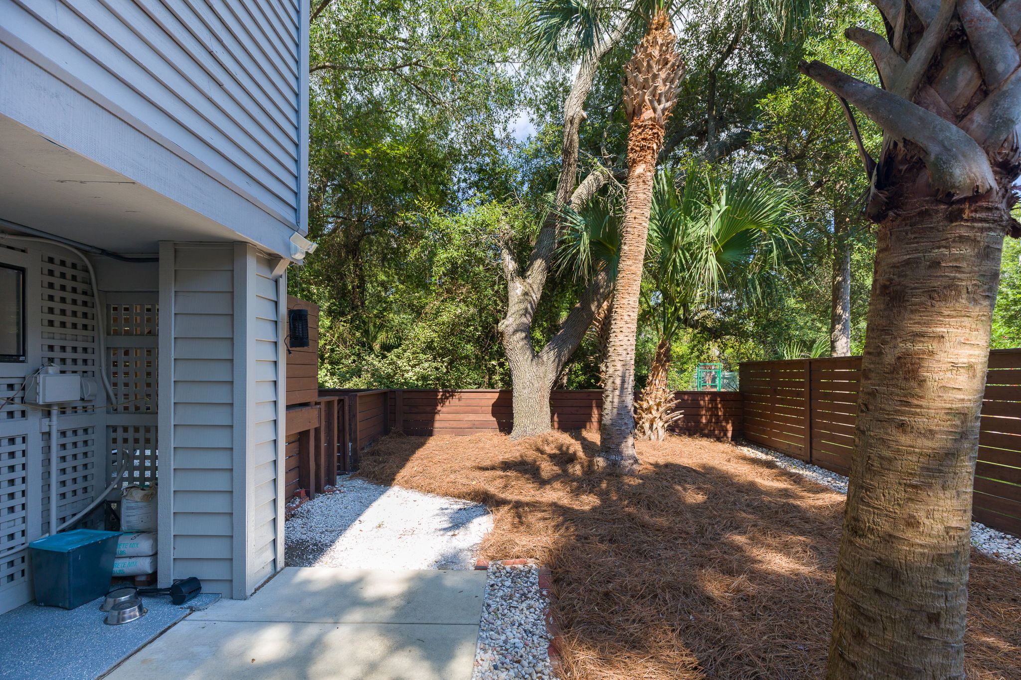 Dog run is fenced and shaded.