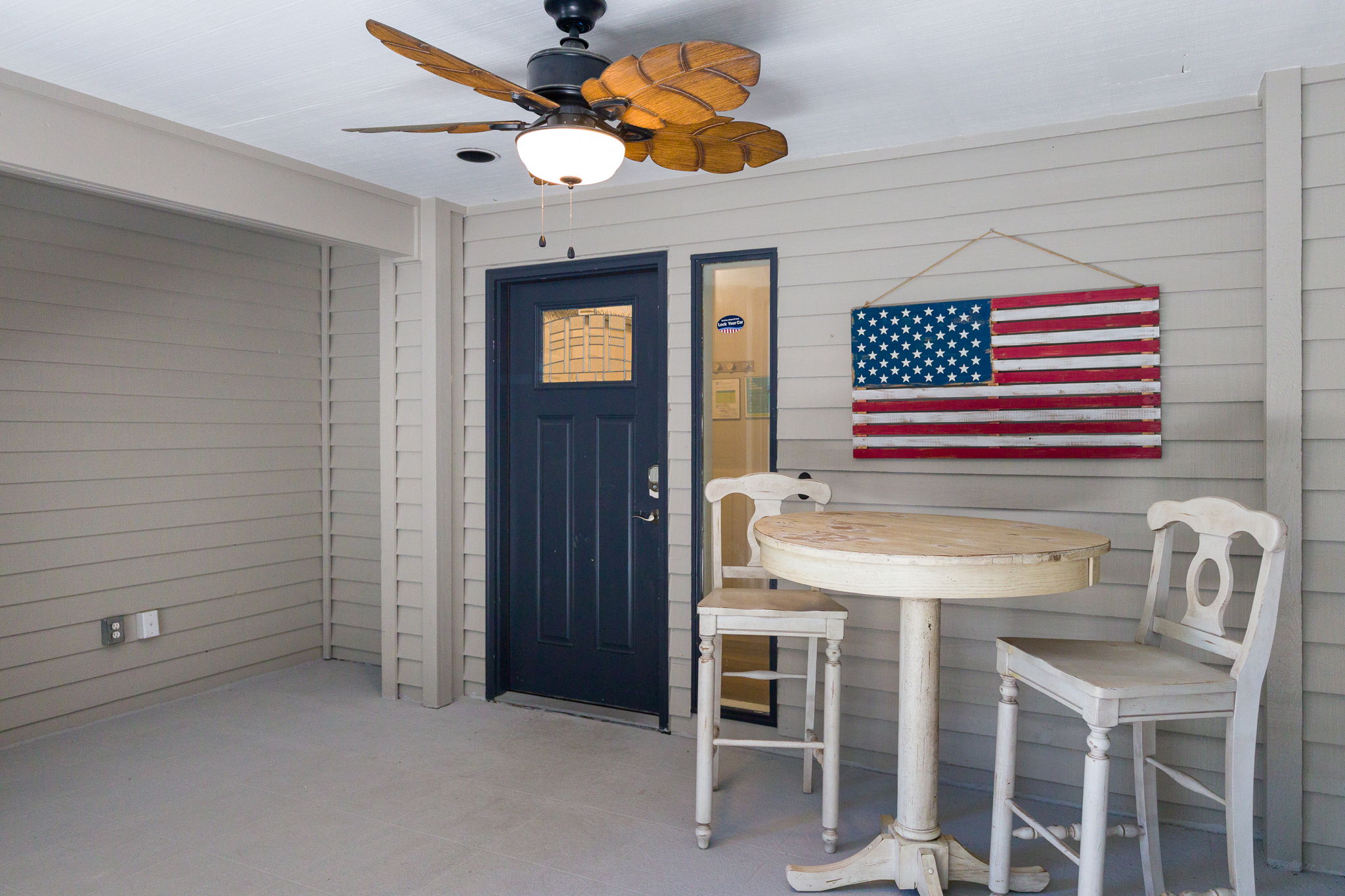 Secure front door with keypad lock and seating area.