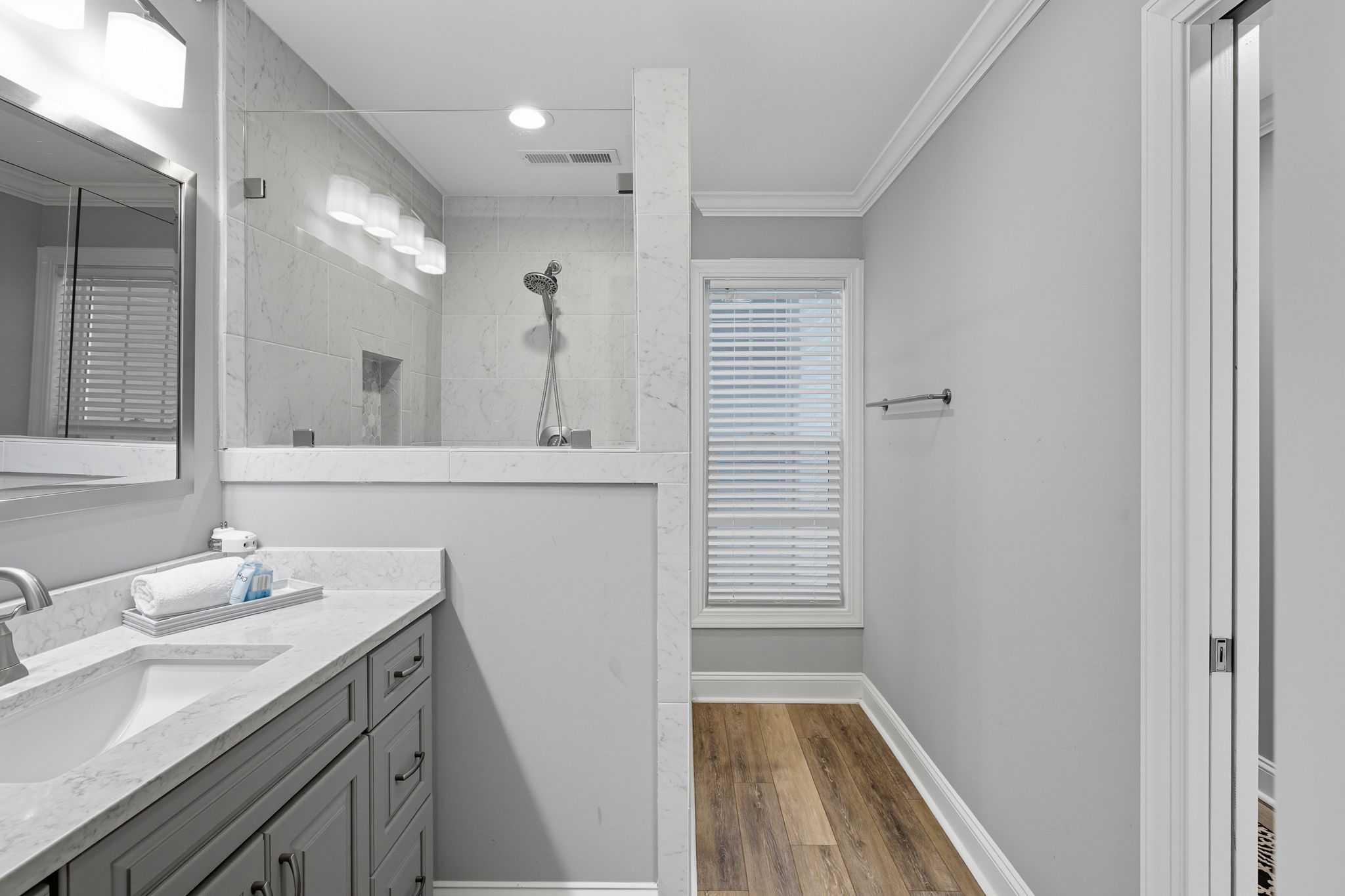Primary bathroom with natural light & neutral colors.