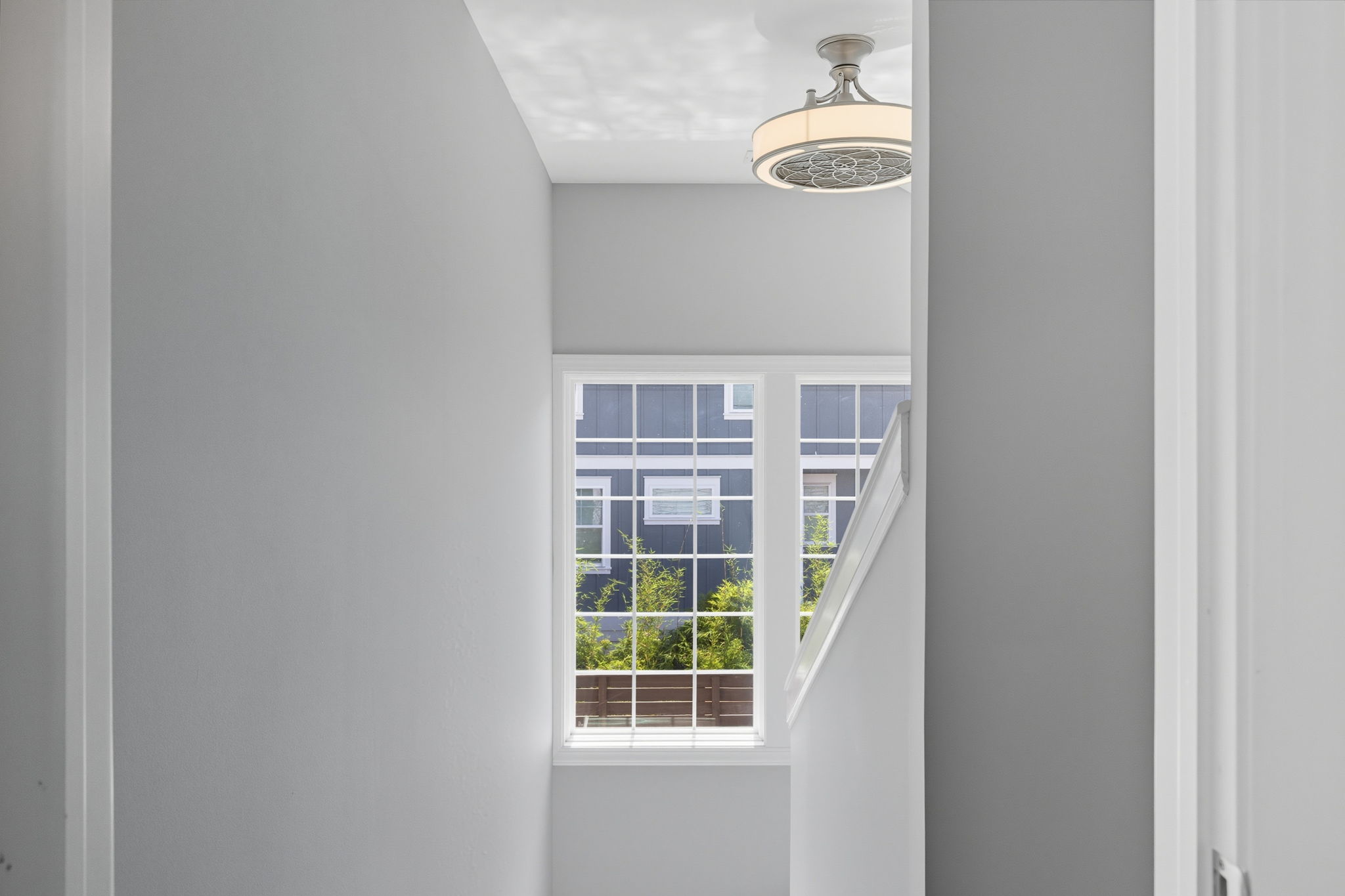 The landing and stairwell leading to the second floor has loads of natural light.