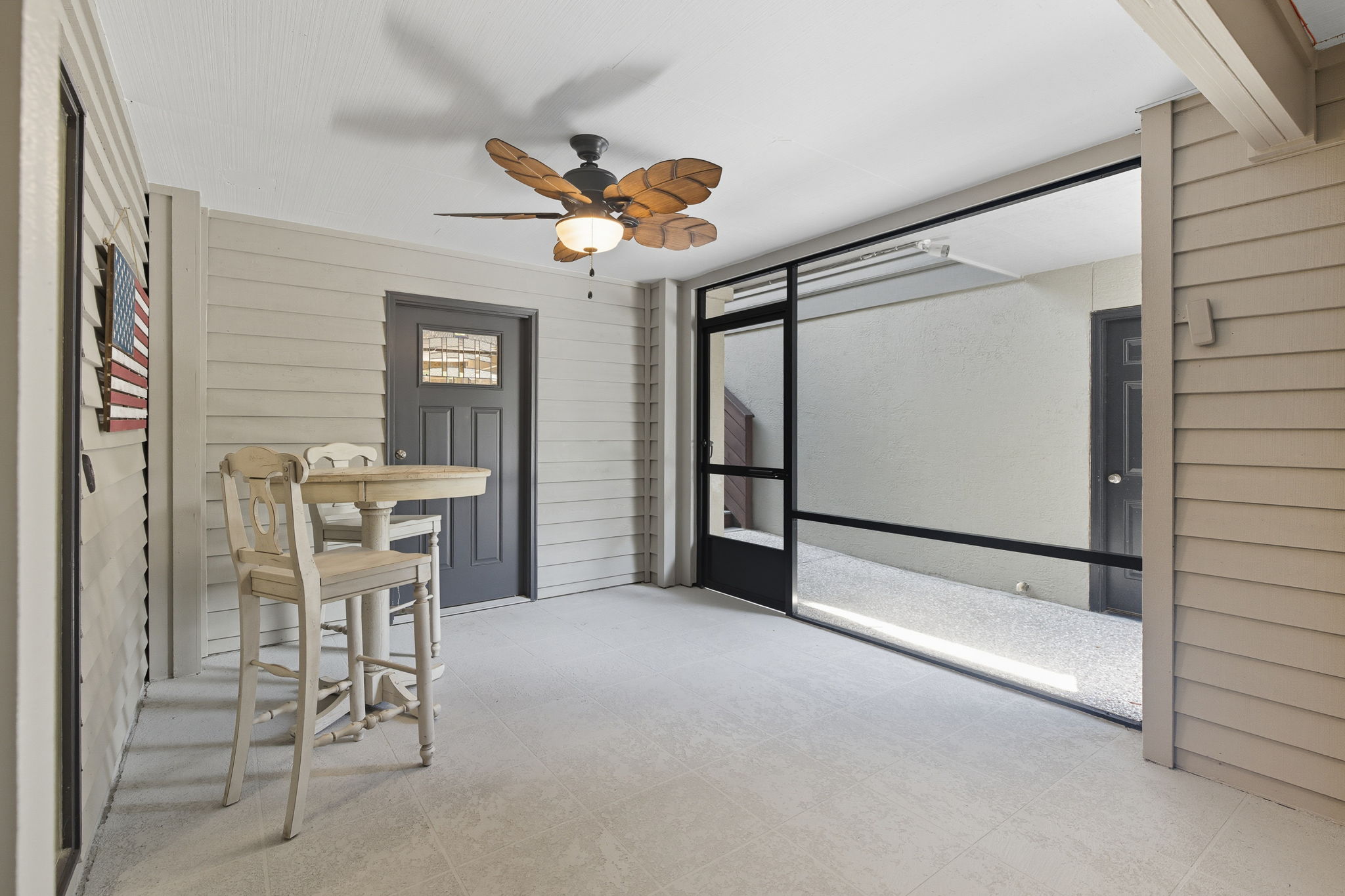 Screened in porch - perfect place for surf boards & beach gear.