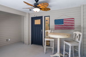 Secure front door with keypad lock and seating area.