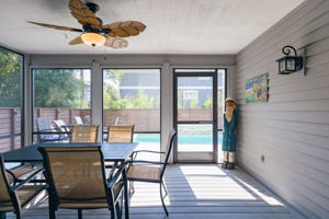 The screened in porch overlooks and has access to the pool.