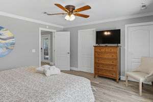 Primary King bedroom w/large closet, dresser and flat screen TV.
