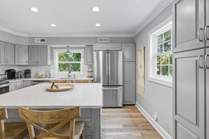 Kitchen with light from 2 aspects; the Island seats 4.
