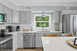 Stainless steel appliances grace the kitchen.