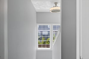 The landing and stairwell leading to the second floor has loads of natural light.