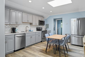 A table for four is convenient to the kitchen.