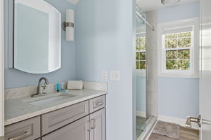 A pretty bathroom with vanity and walk in shower in the In-law/nanny suite.