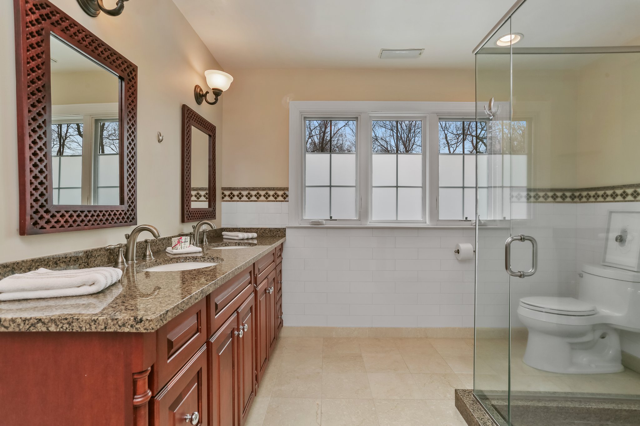 Bathroom 4 - Double sinks with frameless glass shower.