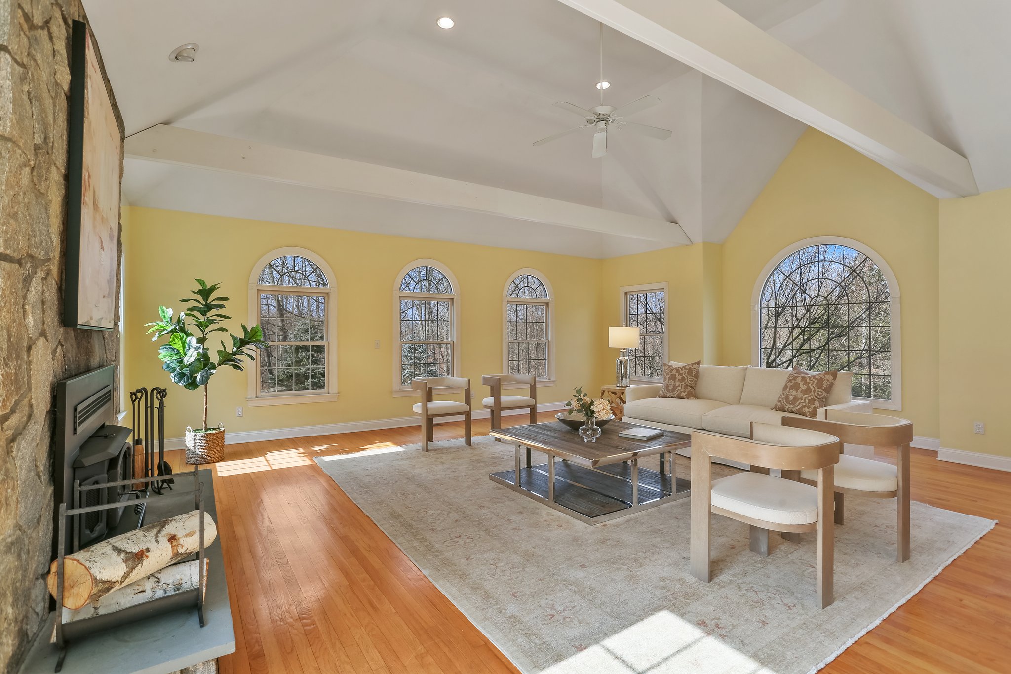 Generous sized Great Room, flooded in natural light with wood-burning fireplace.