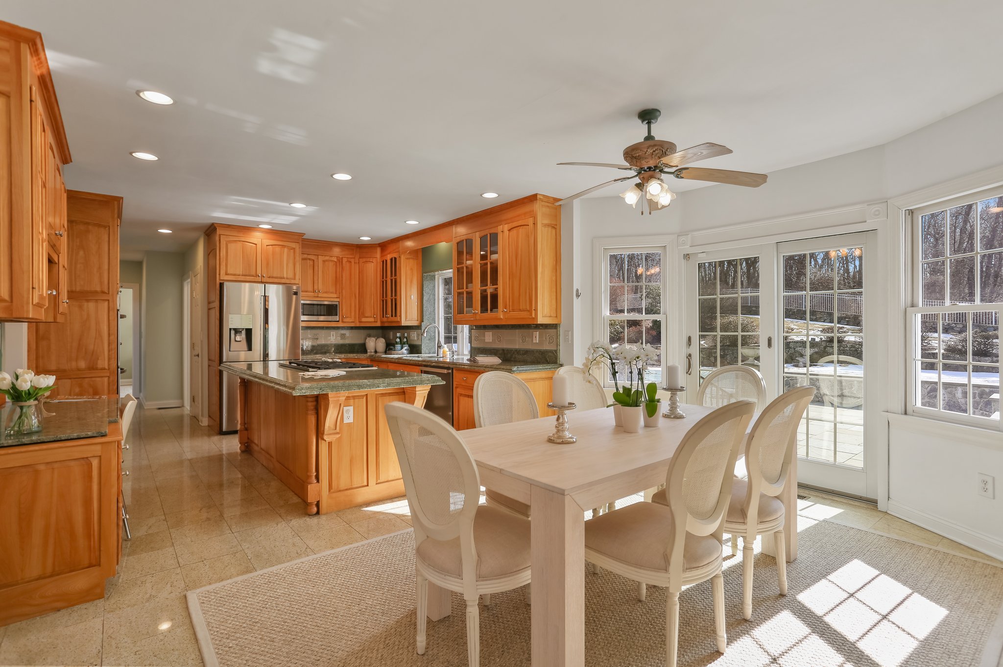 Eat-In Kitchen flooded in light with sliders leading you to your outdoor patio and heated in-ground pool