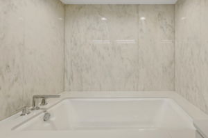 Pamper yourself in the Porcelain tub enclosed in marble to