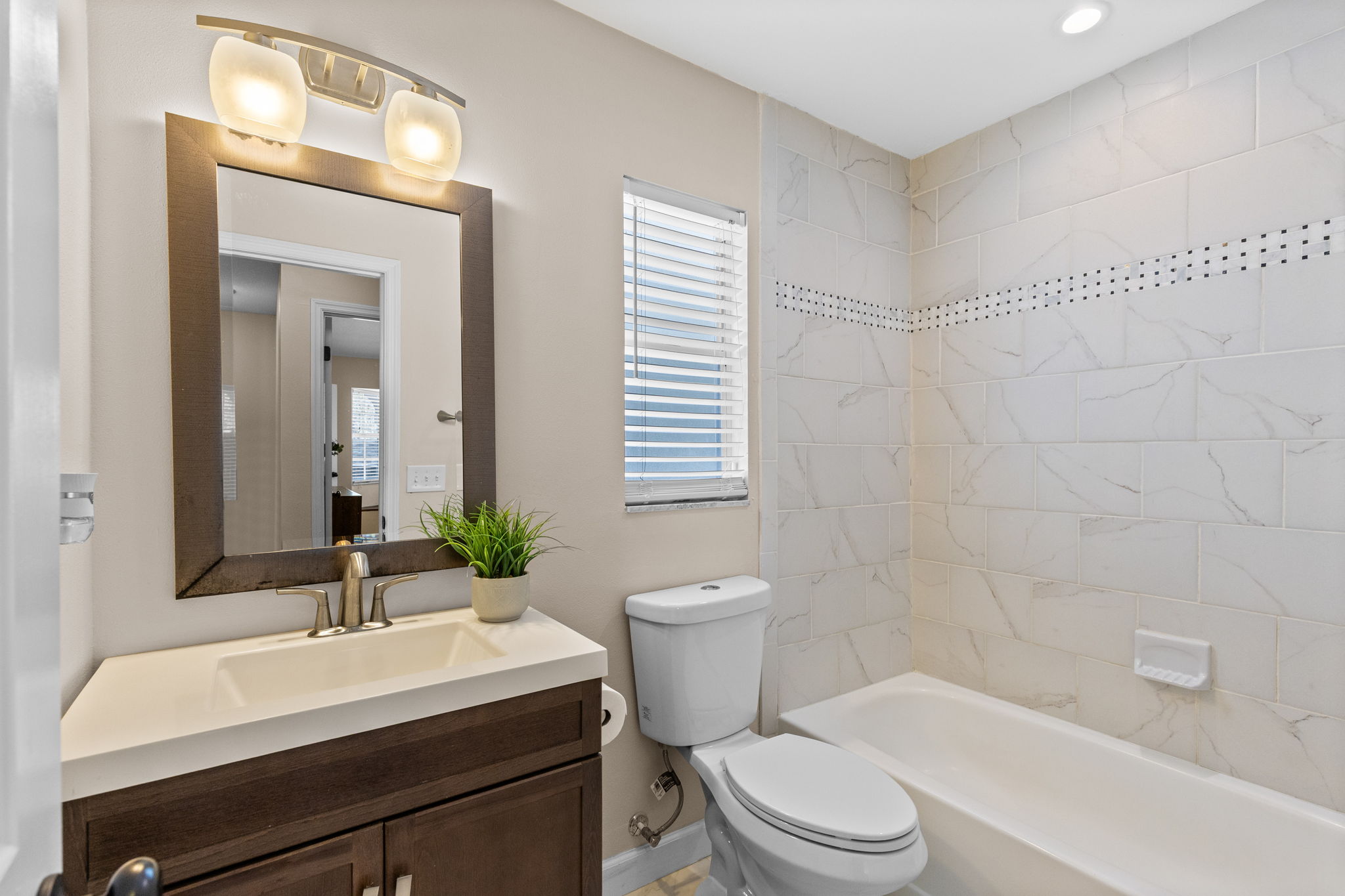 Ceiling hight tile wainscot in Full Second Bathroom upstairs