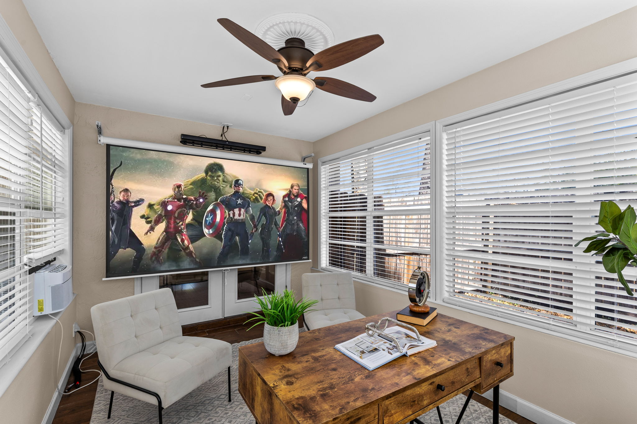 Versatile first-floor media room or study with projector and drop-down movie screen.