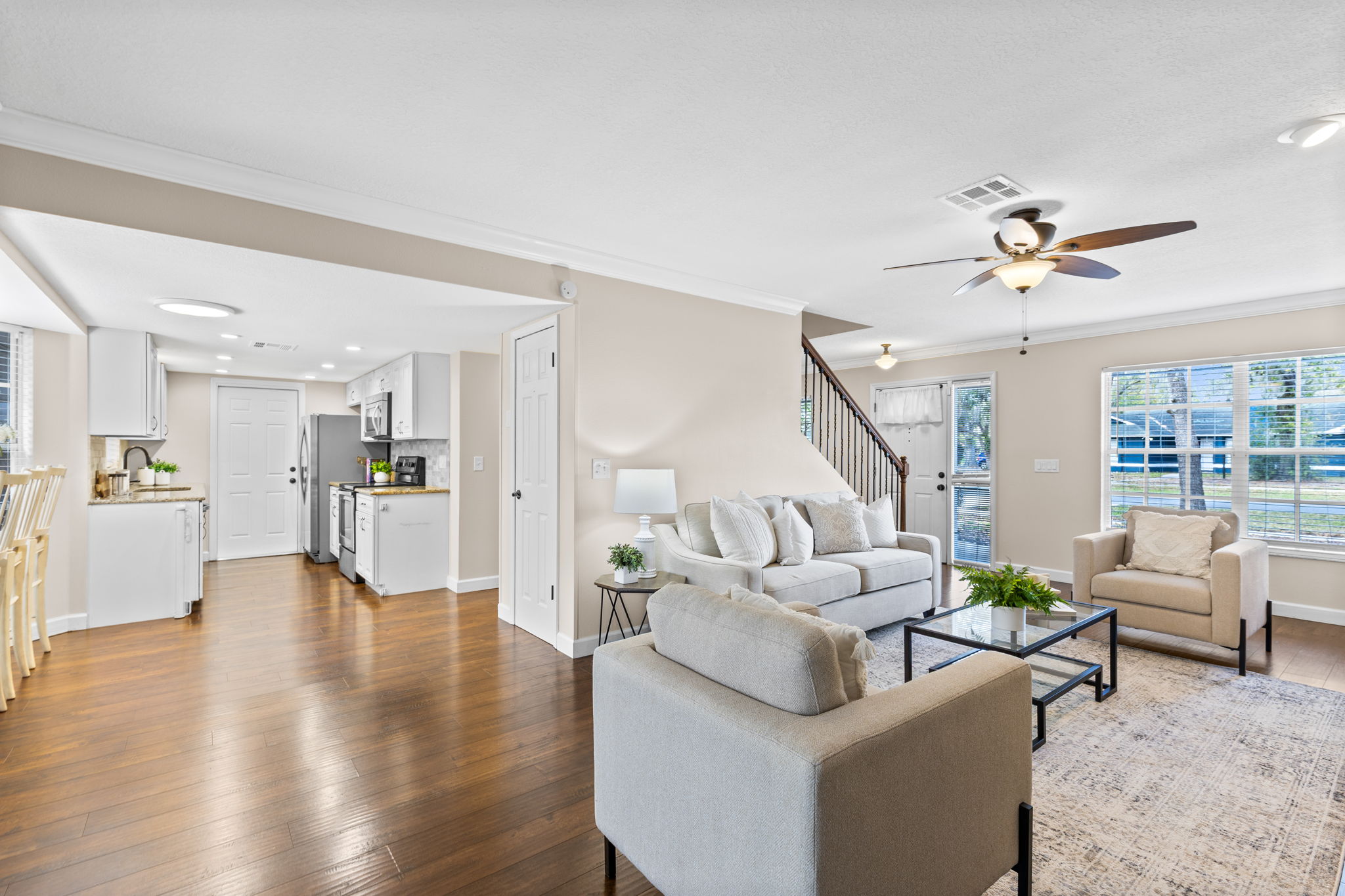 Open living area with abundant natural light and seamless flow between living, dining, and kitchen spaces.