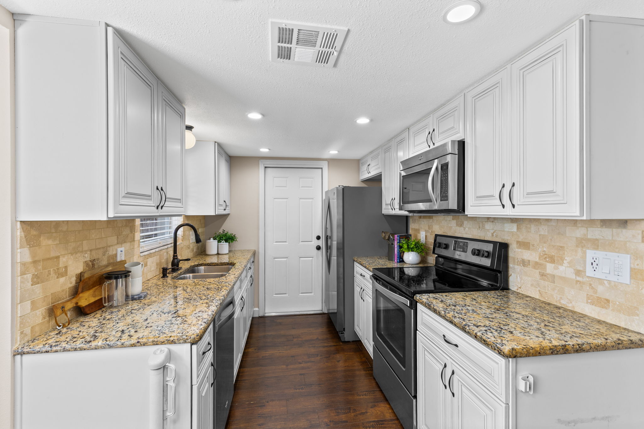 Kitchen features double stainless steel sink, granite counters, and soft-close cabinetry.