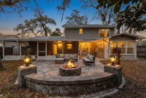 Expansive paver patio with built-in fire pit, perfect for outdoor entertaining and relaxing evenings.