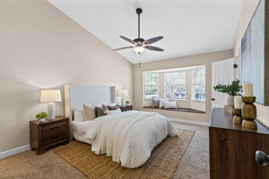Primary suite with charming bay window bench nook and natural light.