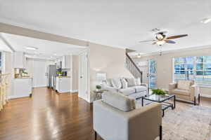 Open living area with abundant natural light and seamless flow between living, dining, and kitchen spaces.