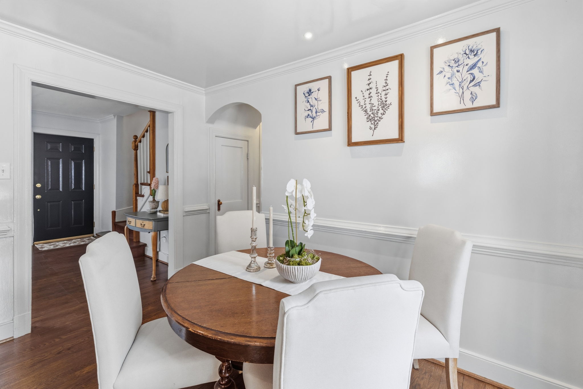 Dining area has crown moulding, recessed eyeball lighting and French doors to the rear.