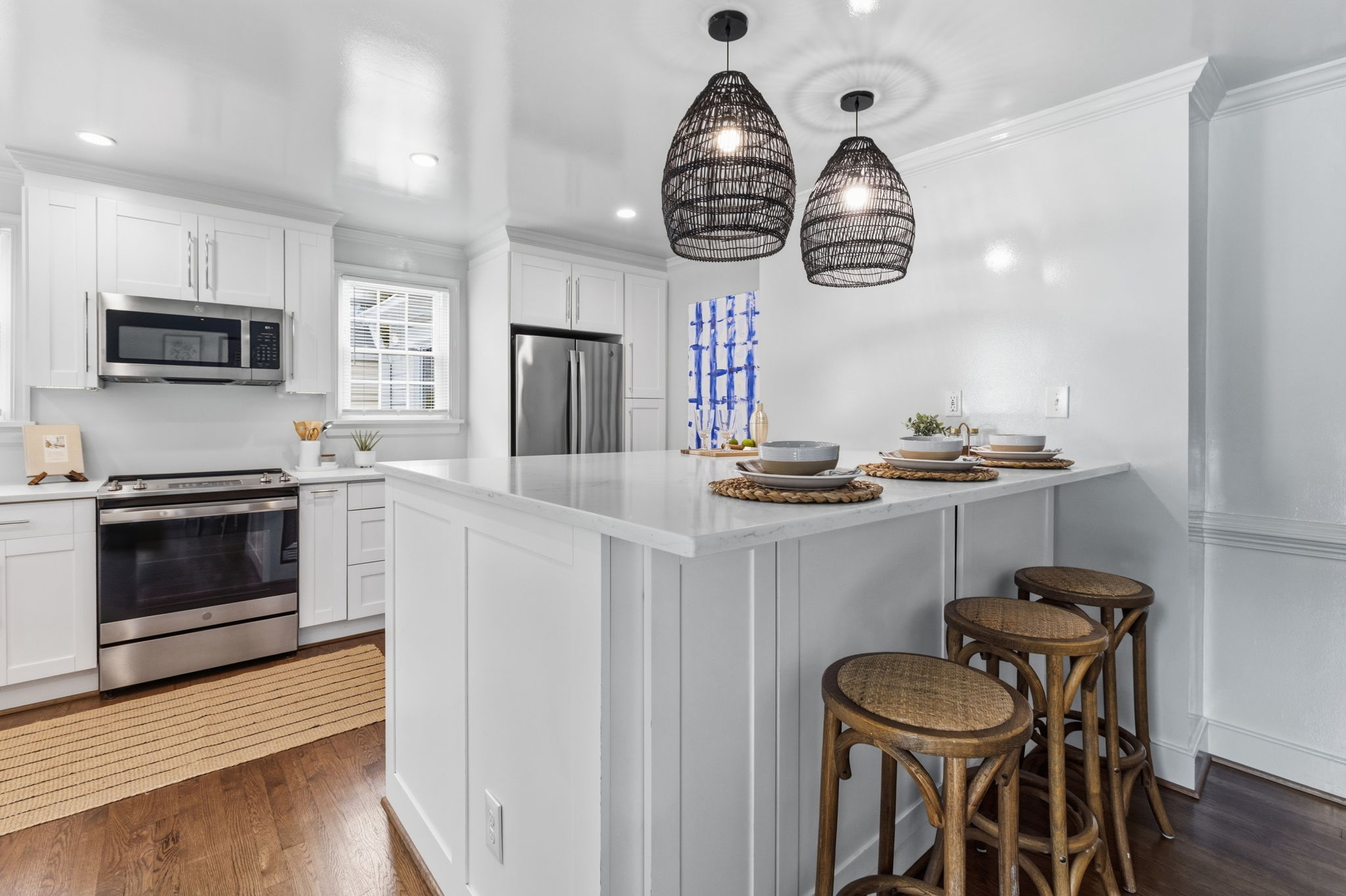 Massive custom kitchen with Quartz counters, crown moulding, recessed can lighting & pendent lighting makes for a nice place to gather.