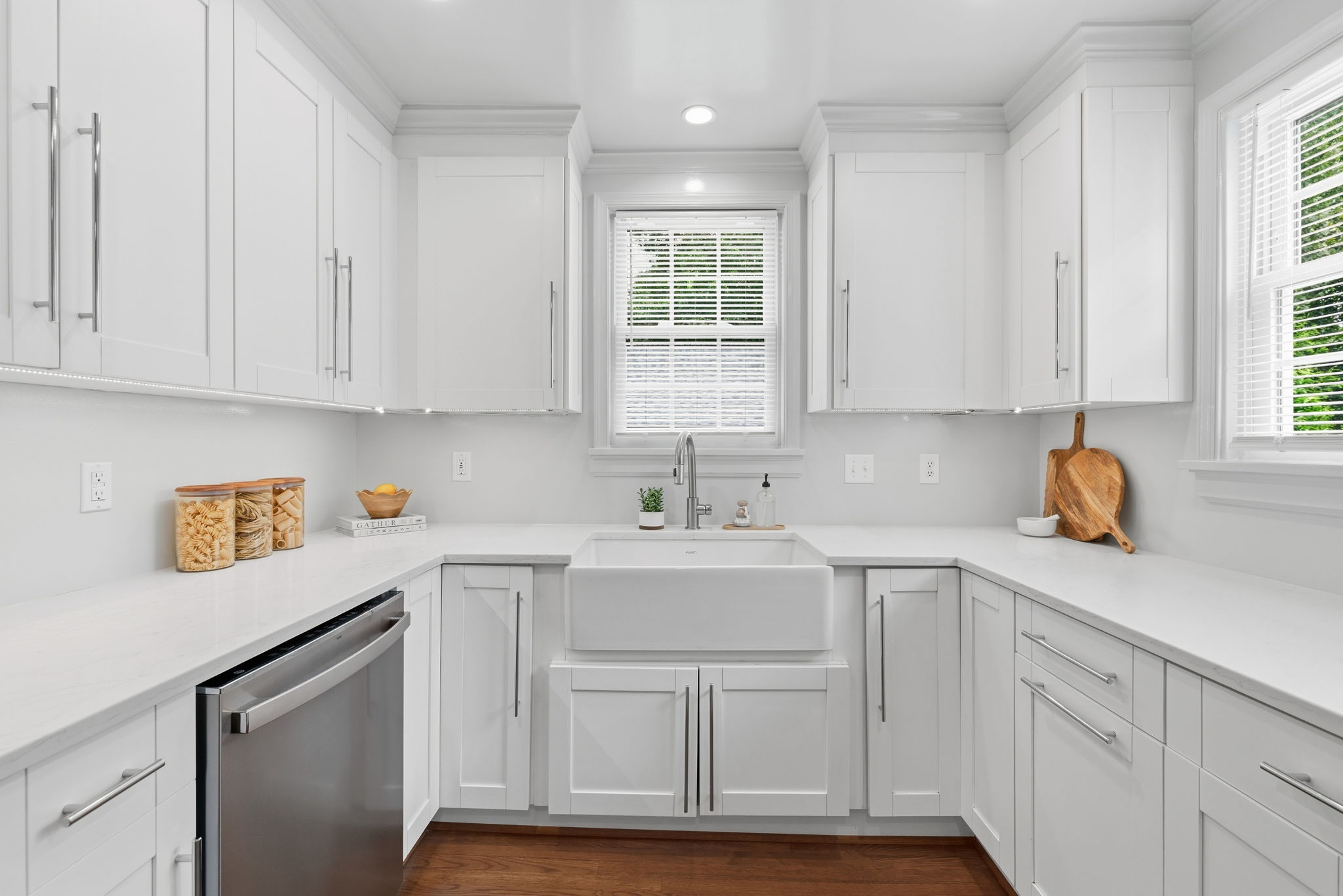 Under cabinet LED lighting & a large farmhouse style sink with disposal.