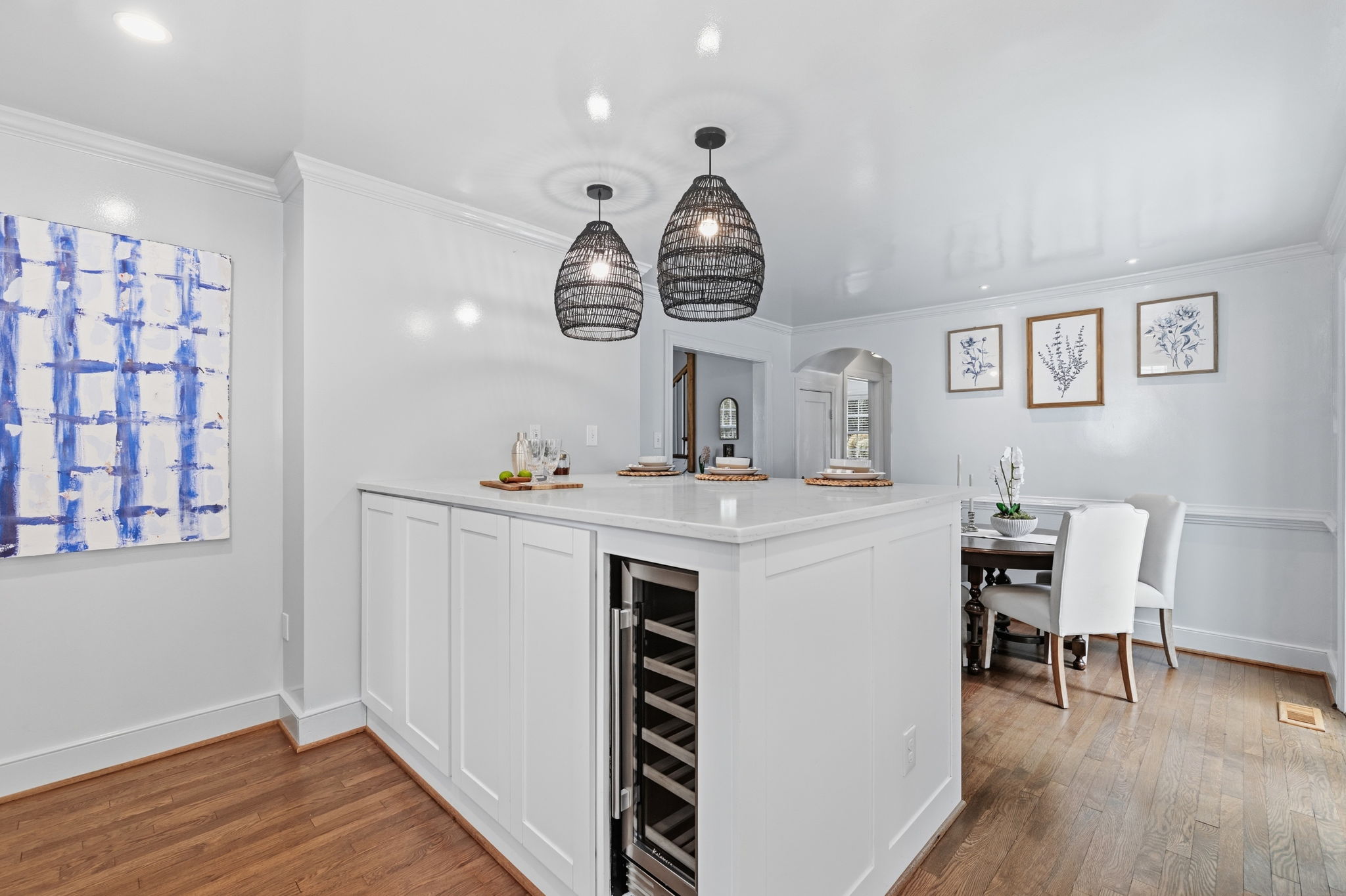 Large custom built peninsula contains some storage space on dining room side, washer and dryer on the kitchen side and a wine/drink refrigerator.