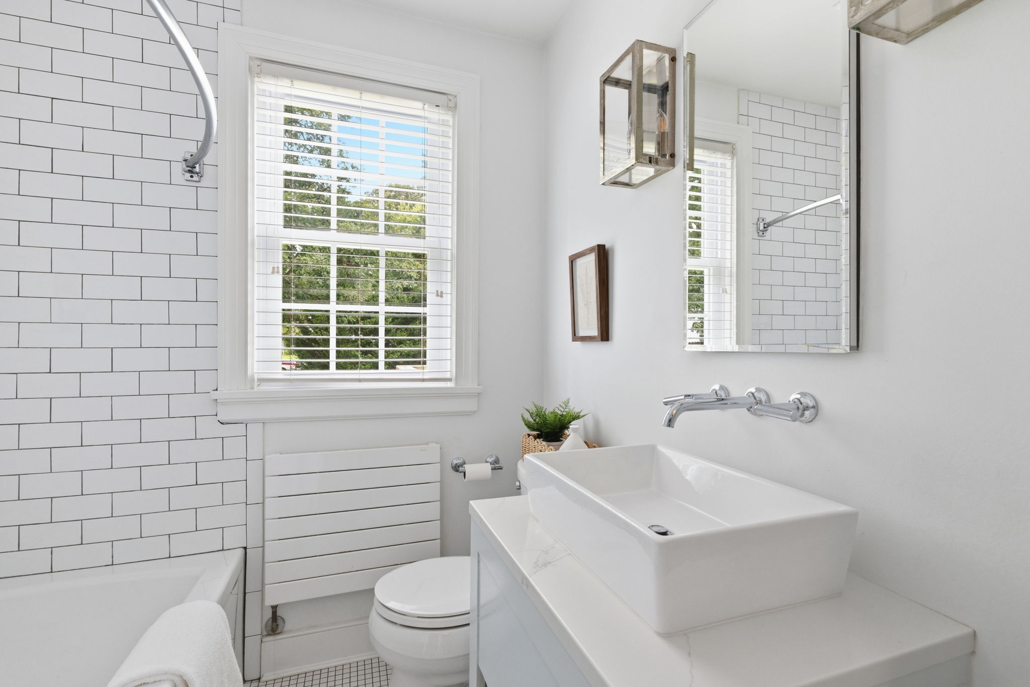 Full 1st floor hall bathroom has been meticulously renovated with a custom built vanity with matching Quartz counters, wall mounted faucet, & heated tile floors.