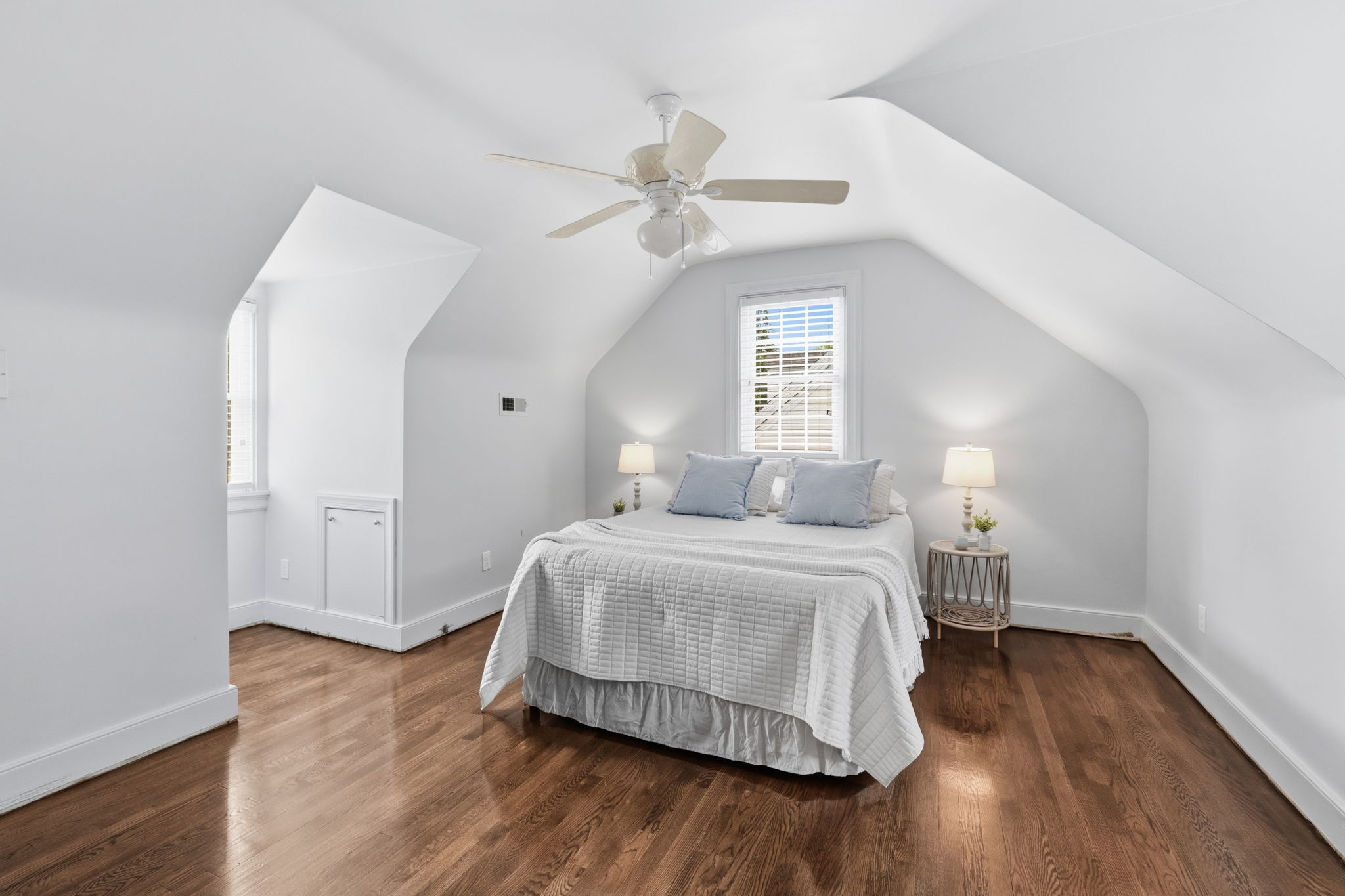 Large front 2nd floor bedroom with eave storage and recently refinished hardwood floors.  Shoe moulding has since been installed after photos!