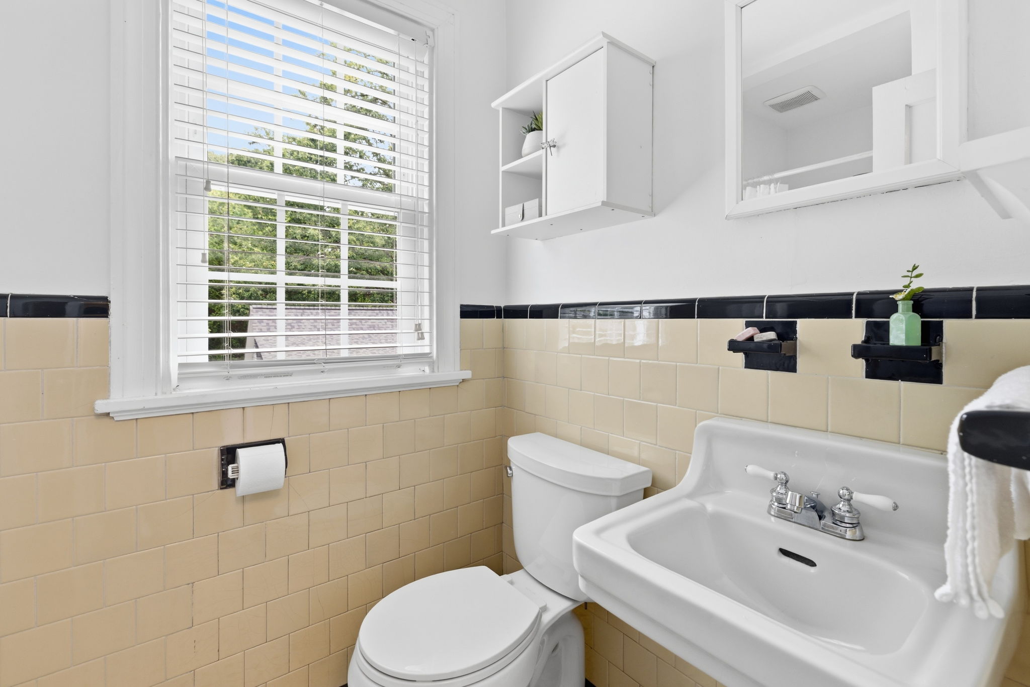 2nd floor hall bathroom with stand up shower and linen cabinet storage.
