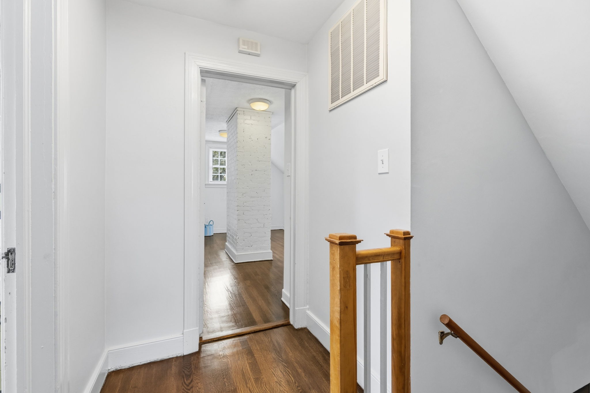 2nd floor landing with refinished hardwood floors.