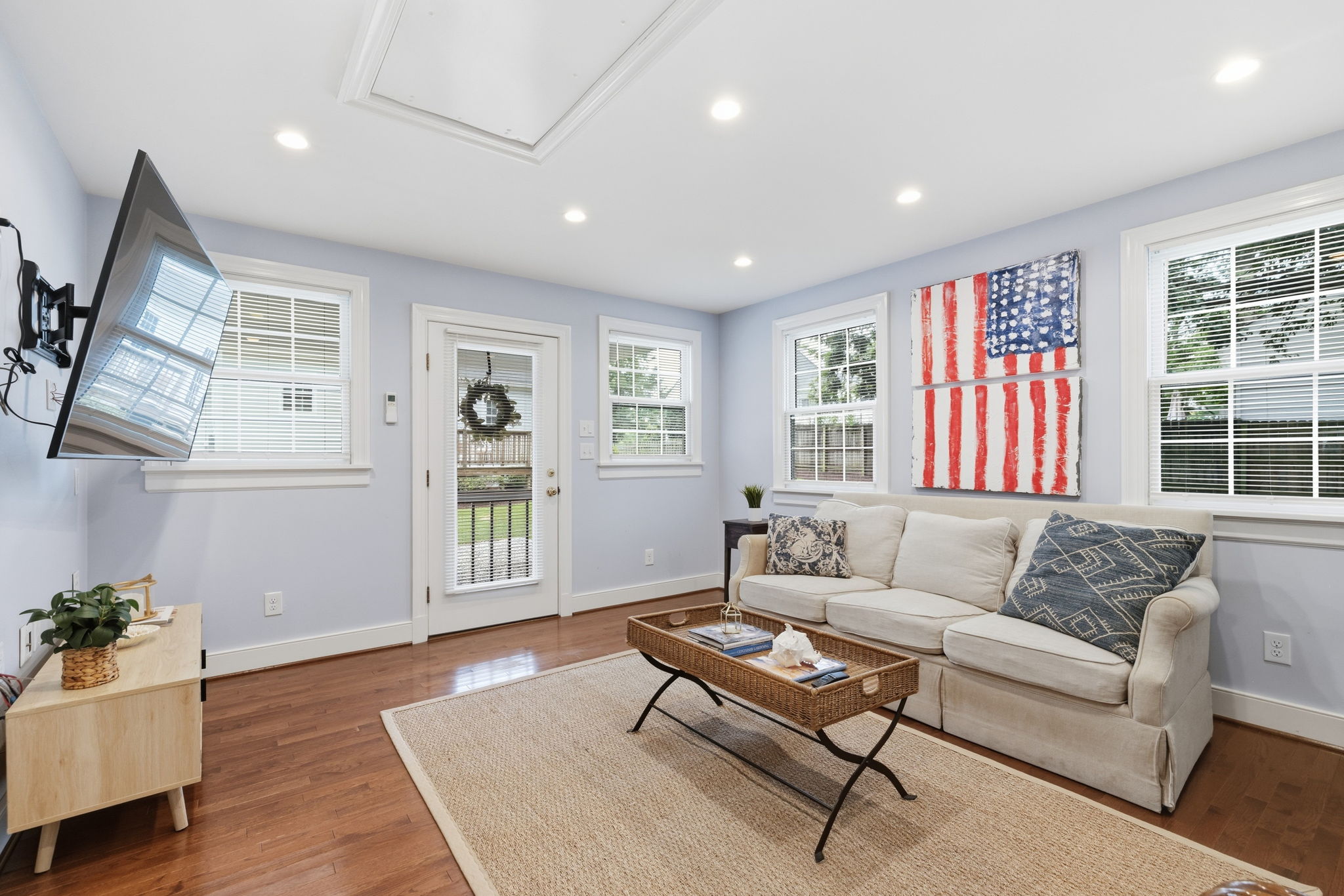 Tons of natural light with numerous windows, a pull down attic, and speaker wires pre run. TV could convey with the right offer!