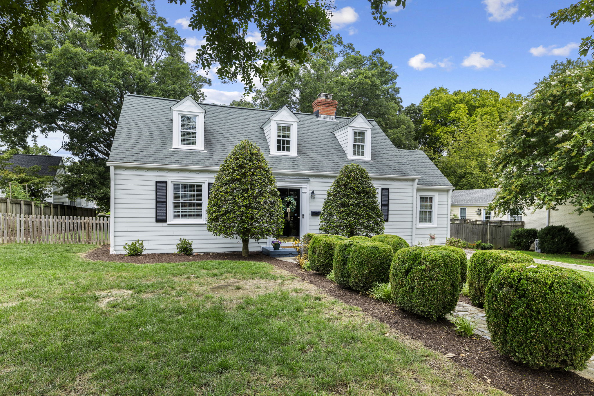 Mature landscaping with established mulch beds & beautiful tree coverage.