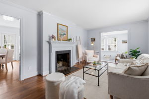 Wood burning fireplace & large cased opening to the dining & kitchen area give it an open feel with defined space, the best of both worlds.