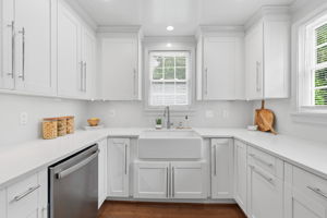Under cabinet LED lighting & a large farmhouse style sink with disposal.