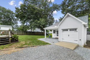 Pull your vehicle right up to the garage with the large gravel driveway and beautiful carriage house style pull up door.