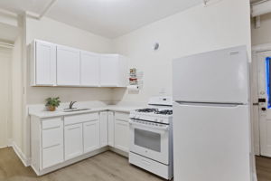 New appliances, quartz countertop, shaker cabinets and easy to care for wood-look plank floor