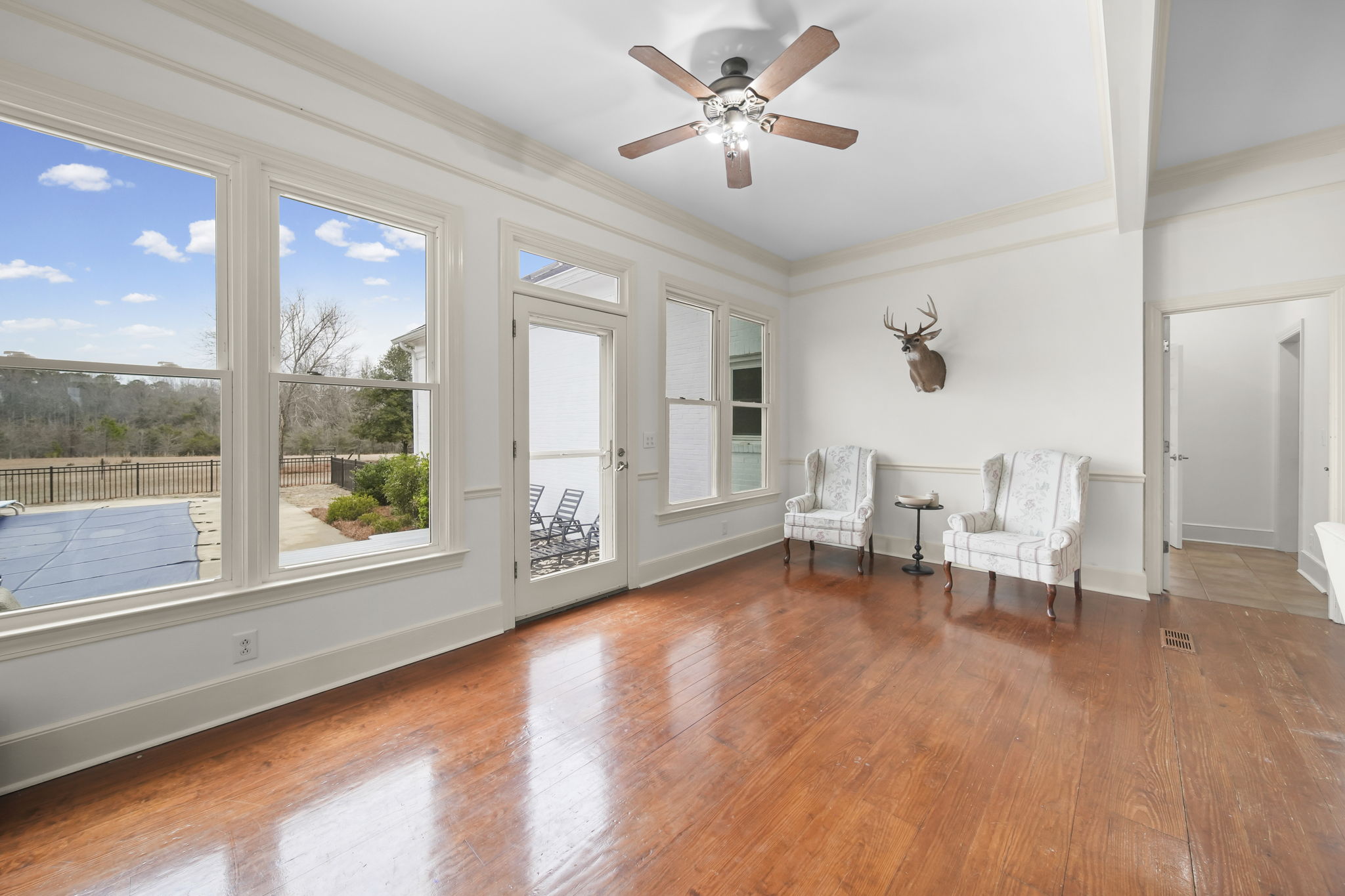 Living Room looking out to Inground Pool in Backyard