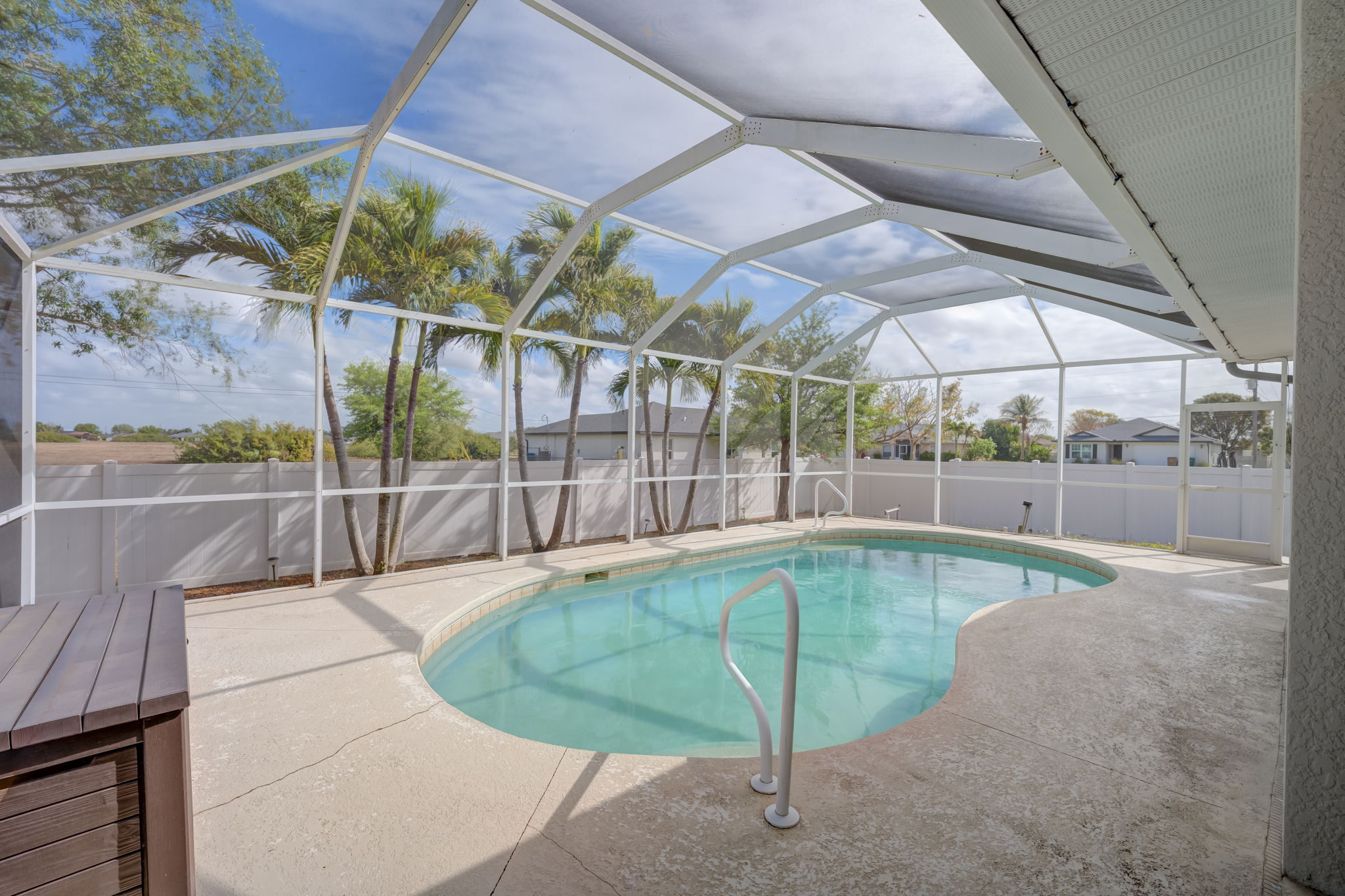 Screren in lanai with view of pool and fenced yard