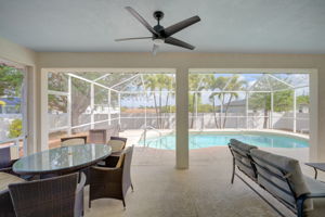 Screren in lanai with view of pool and fenced yard