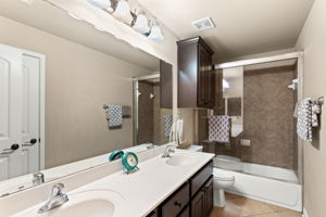 Bathroom with dual vanity perfect for guests / family