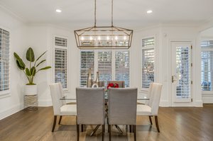 Breakfast area has wall of windows overlooking the back.