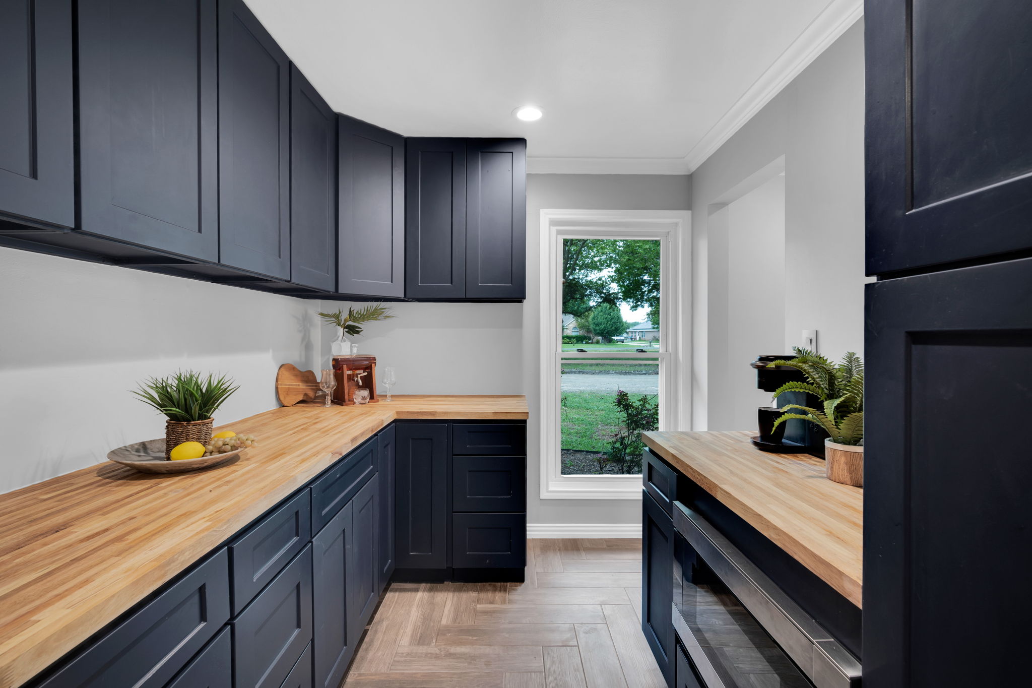 This butler's pantry is designed with efficiency and storage in mind