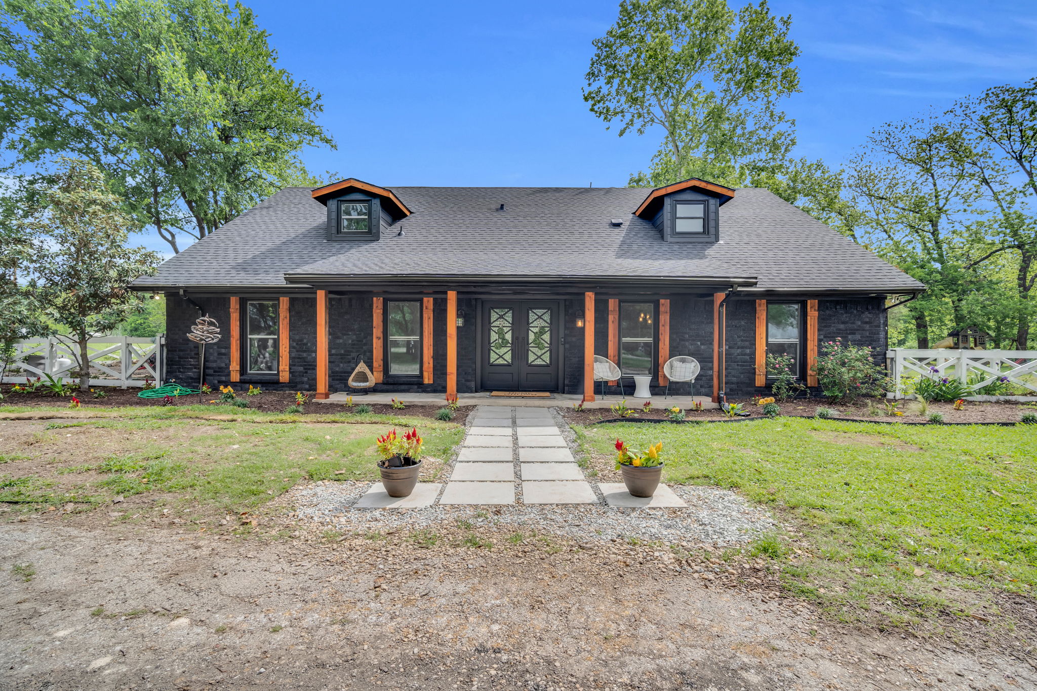 Large pavers create a natural walkway feature to your large iron front doors ready to embrace your presence