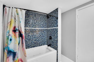 Bathroom with shower/tub combination and a storage nook