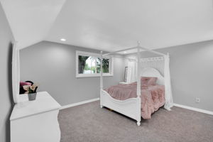 Bedroom features vaulted ceiling and fresh paint