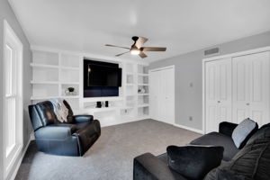 Main floor bedroom with built-in shelves and double closets provides a flexible use option